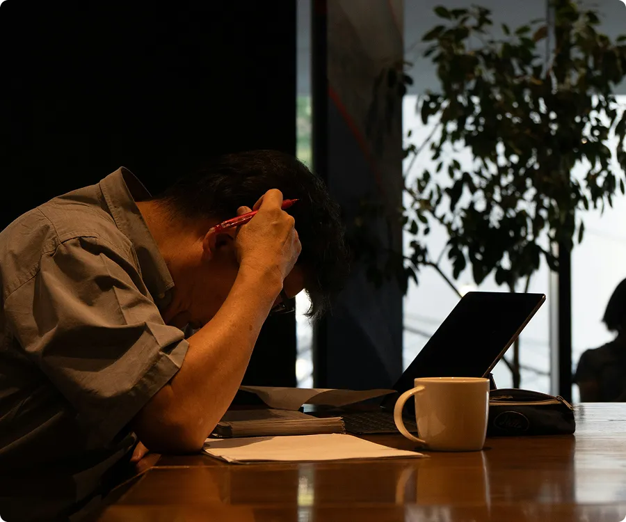 A person resting their head in their hands