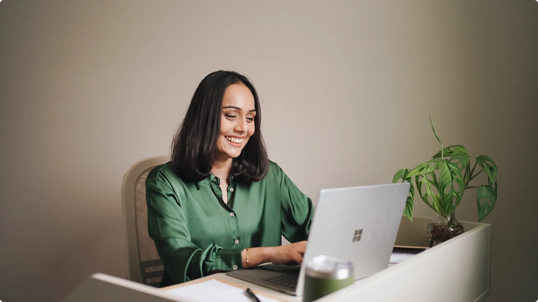 Shabnam Lee smiling at her laptop during an online session